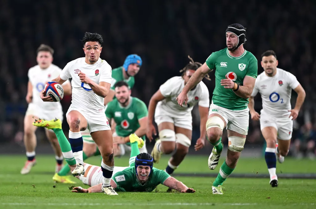 LONDON, ENGLAND - MARCH 09:  Marcus Smith of England makes a breaks clear from Ryan Baird and Caelan Doris of Ireland during the Guinness Six Nations 2024 match between England and Ireland at Twickenham Stadium on March 09, 2024 in London, England. 